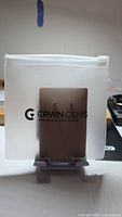 Earrings packaged in CRWN GEMS zip pouch on display stand