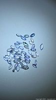 Loose marquise-cut tanzanites scattered on surface