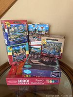 Front view of all six boxed puzzles stacked