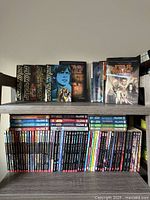 Two shelves filled with Star Wars novels, paperbacks below, hardcovers above