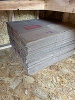 Full stack of flat Public Storage boxes on plywood floor