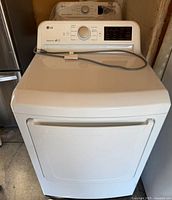 Front three-quarter view of LG electric dryer showing door and control panel