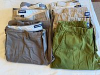 Two stacks of folded Lands’ End pants in various colors