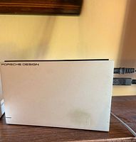 Left-side view showing Porsche Design branding and connected cables