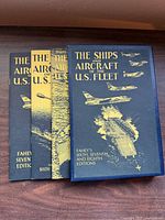 Front view of all three editions with blue covers and gold illustrations