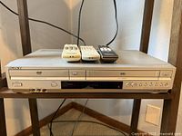 Front view of Sony SLV-D370P combo unit with three remotes on top