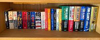 Full shelf showing complete lot of Tom Clancy books