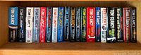 Shelf view showing all 21 Tom Clancy hardcover novels listed