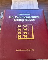 Front cover of maroon binder titled 'U.S. Commemorative Stamp Blocks'