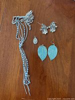 All jewelry items laid on wood surface