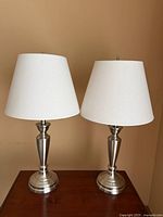 Full view of both chrome table lamps with shades