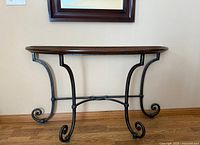 Full view of console table showing wood top and wrought iron base