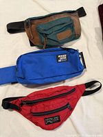 All three waist packs laid out to show colors and overall condition
