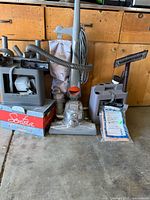 Front view of Kirby vacuum, accessory caddy on left, Sentria box below, accessory caddy on right with bag pack