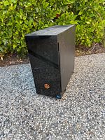Front view of black PC tower with orange logo and Intel sticker