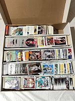 Overhead of full long box showing three filled rows of trading cards