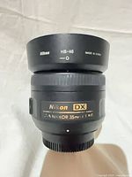 Front view of Nikon 35mm f/1.8G lens with HB-46 hood attached