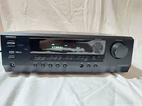 Front view showing display, controls, volume knob