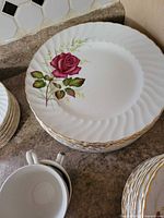 Stack of dinner plates with rose motif