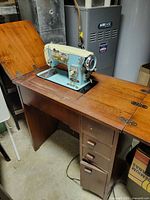 Machine in open cabinet showing color, mounting, foot pedal