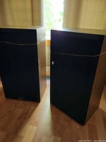 Both speakers front view with grilles and wires