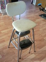 Front view of chrome chair with white vinyl seat/back and two black steps