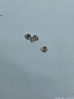 Four loose round diamonds grouped on neutral background