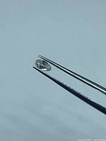 Diamond held in tweezers side view