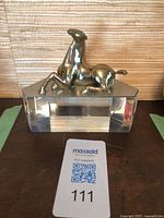 Brass horse figurine on clear lucite base front view