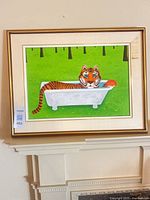 Full view of framed painting on wall showing artwork and frame