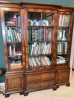 Front view showing full cabinet with books inside