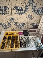 Full lot overview on table showing trays of jewellery and boxes