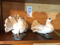 Front view of both Rosenthal porcelain dove figurines on shelf