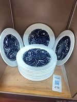 Stack of twelve plates showing design and quantity