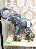 All three elephant figurines on table