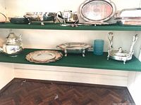 Overall view of silver plated pieces on shelves