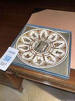 Plate in open presentation box showing full design