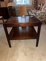 Angled view showing top and shelf of walnut side table