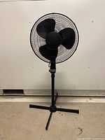 Full front view of black pedestal fan