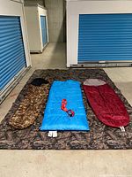 All three sleeping bags laid out on tent fabric