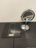 Overall view of Etekcity scale and chrome vanity mirror on tabletop