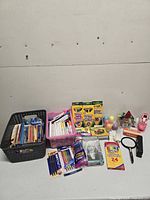 Entire assortment laid out showing art supplies, office items, baskets