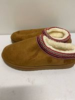 Side view of both slippers showing exterior material and trim