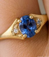 Front view showing oval tanzanite and side diamonds