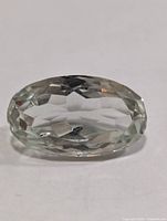 Front view of faceted oval pale green amethyst