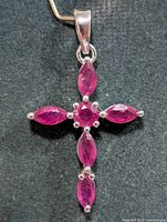 Front view showing cross shape and six ruby stones