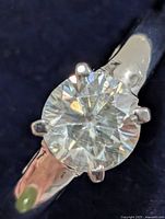 Close-up of moissanite stone in six-prong silver setting