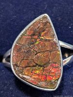 Front view of ammolite ring showing gemstone color and bezel