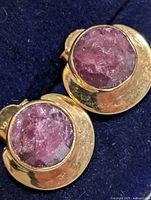 front view of both earrings showing dyed ruby stones and gold-tone settings