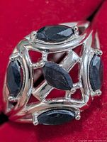 Front view of sterling silver ring with marquise sapphires